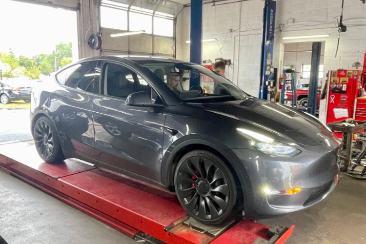 silver tesla on an alignment machine