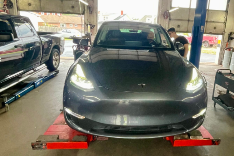 silver tesla getting an alignment service